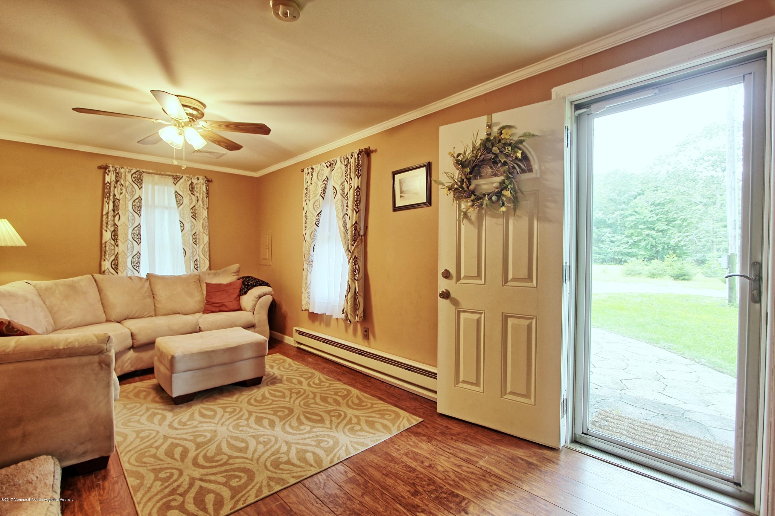 49 Siloam Road Freehold, NJ 07728 - Photo 9 of 38 a living room with furniture and a large window