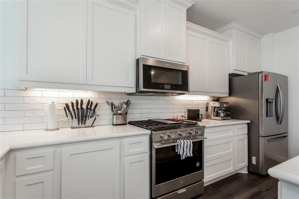 1737 Dalhart Road Plano, TX 75075 - Photo 12 of 28 a kitchen with granite countertop cabinets stainless steel appliances and wooden floor