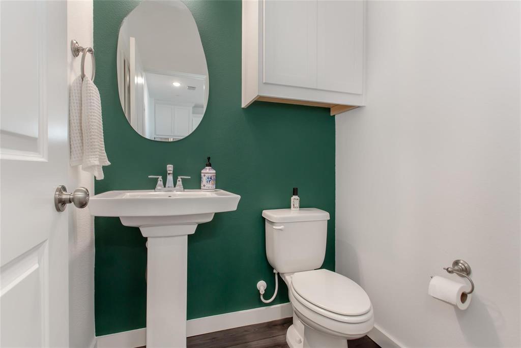 1737 Dalhart Road Plano, TX 75075 - Photo 13 of 28 a bathroom with a toilet sink and mirror
