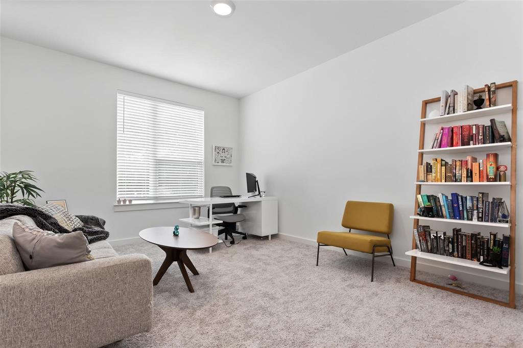 1737 Dalhart Road Plano, TX 75075 - Photo 16 of 28 a living room with furniture and a book shelf