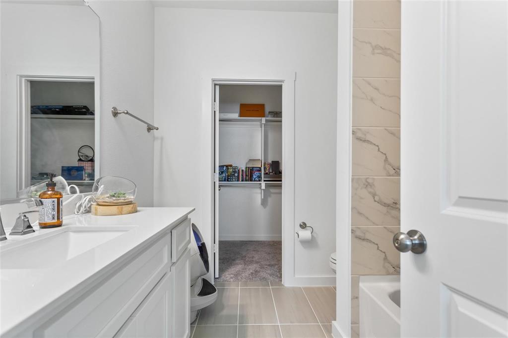 1737 Dalhart Road Plano, TX 75075 - Photo 21 of 28 a bathroom with a sink and a mirror