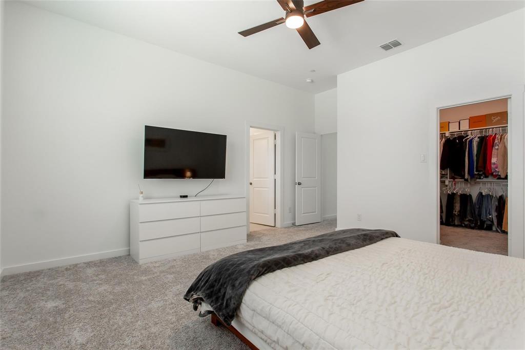 1737 Dalhart Road Plano, TX 75075 - Photo 23 of 28 a bedroom with a bed and a flat tv screen on dresser