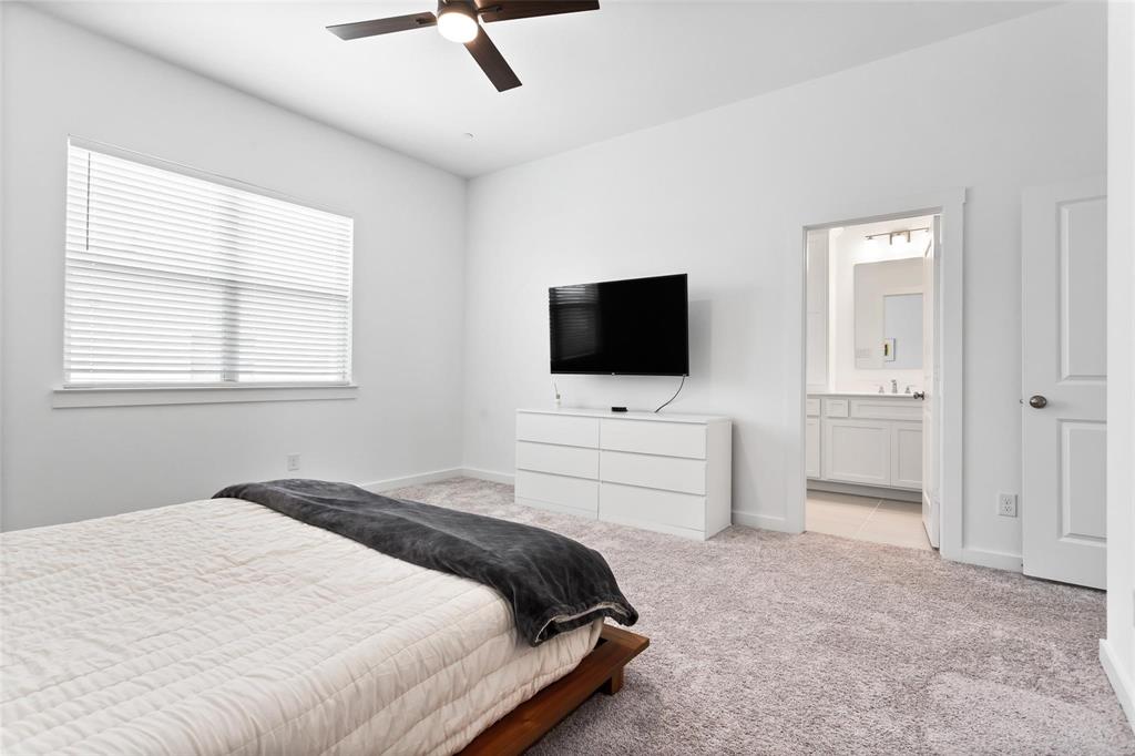 1737 Dalhart Road Plano, TX 75075 - Photo 24 of 28 a bedroom with a bed and a flat screen tv