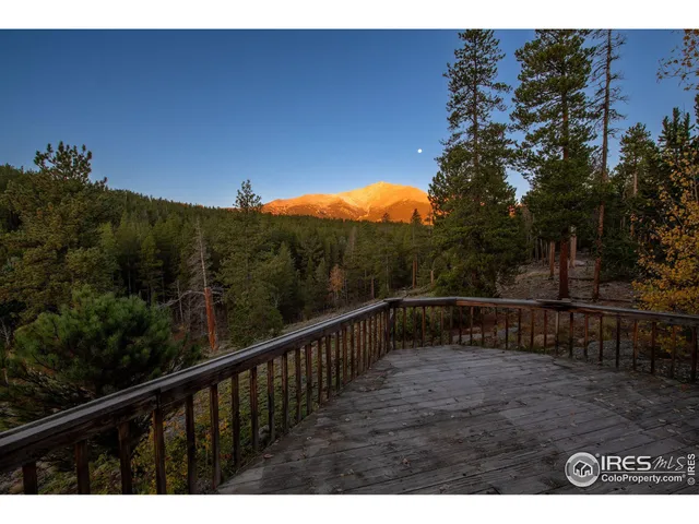 a view of a balcony with wooden fence