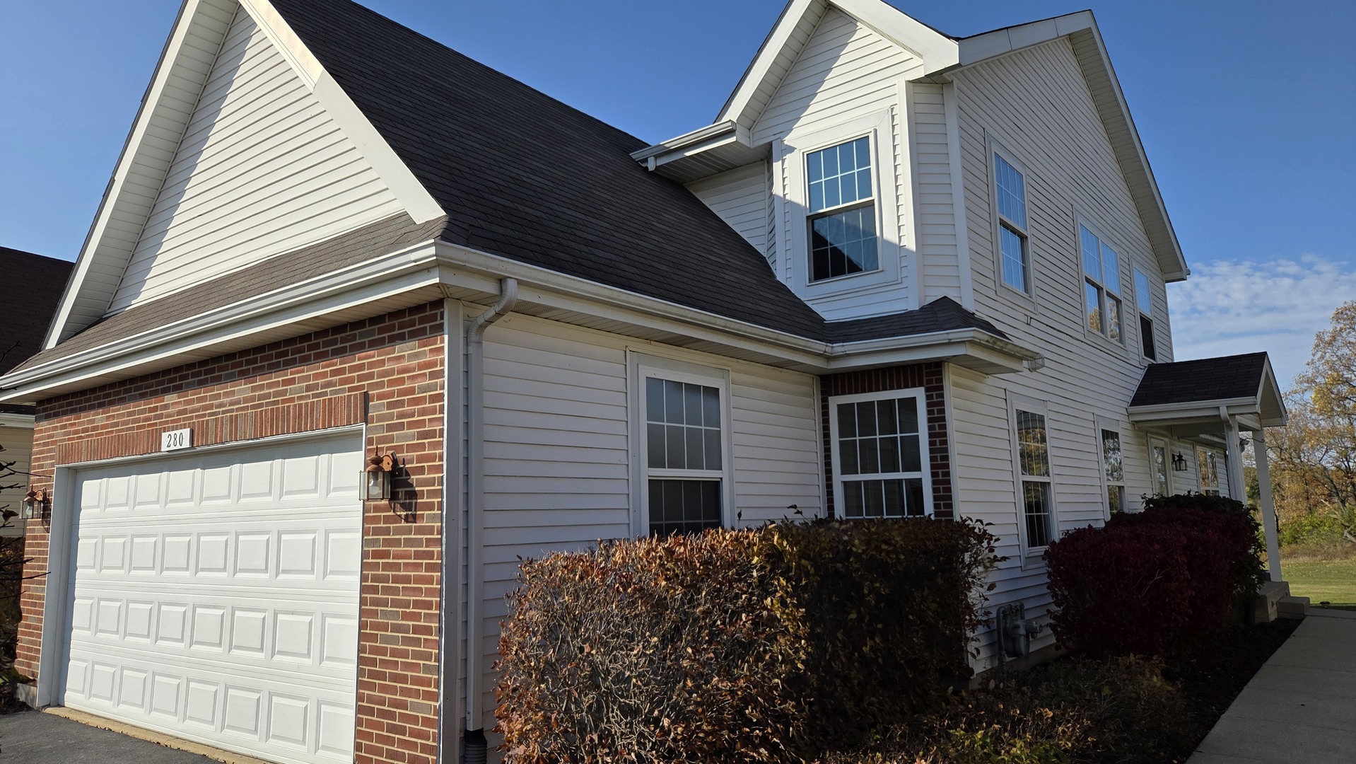 a view of a house with a car side of garage