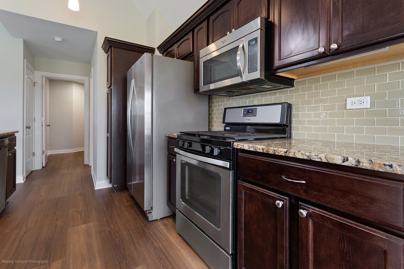 280 Sunset Boulevard Beecher, IL 60401 - Photo 6 of 48 a kitchen with stainless steel appliances granite countertop a stove microwave and refrigerator