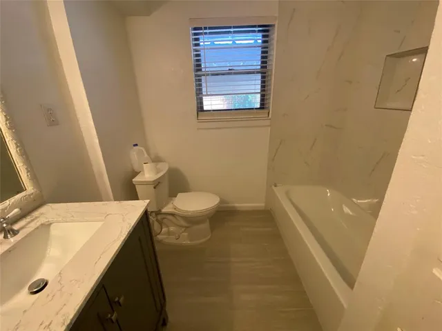 a bathroom with a tub a sink and a shower