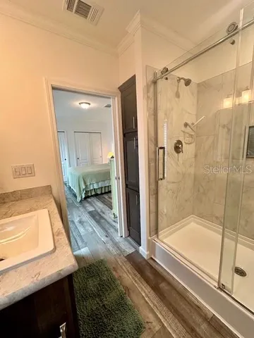 a bathroom with a granite countertop toilet sink and mirror