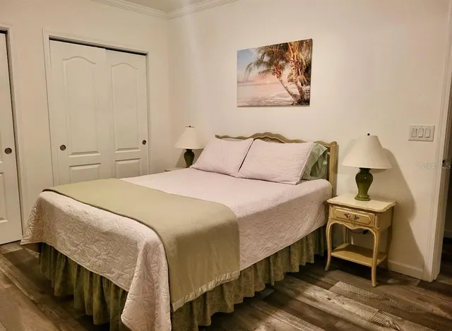 a bedroom with a bed and a chandelier