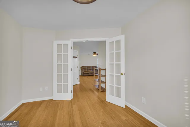 a view of empty room with wooden floor