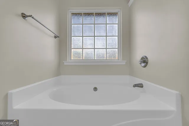 a white bath tub sitting next to a window