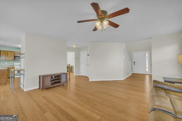 a view of empty room with wooden floor