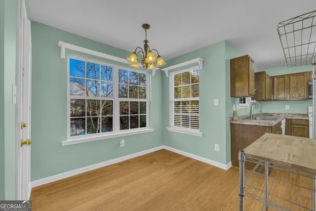 a view of an empty room with a kitchen
