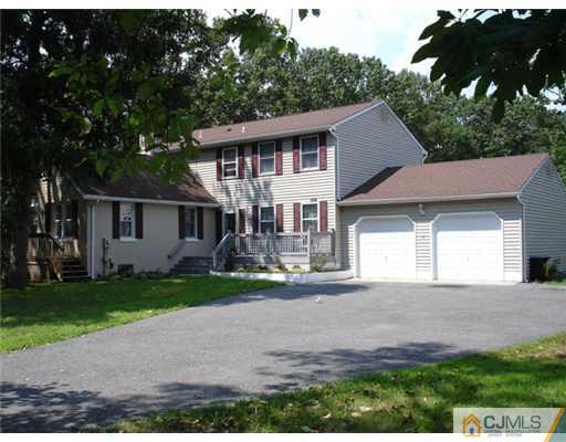 800 Farmingdale Road Jackson, NJ 08527 - Photo 1 of 22 a front view of a house with a yard and garage