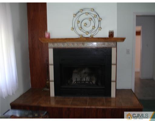 800 Farmingdale Road Jackson, NJ 08527 - Photo 11 of 22 a living room with a fireplace and a wooden floor