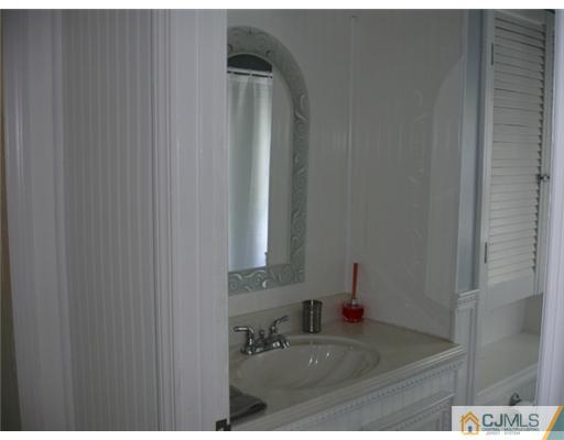 800 Farmingdale Road Jackson, NJ 08527 - Photo 12 of 22 a bathroom with a sink and a mirror