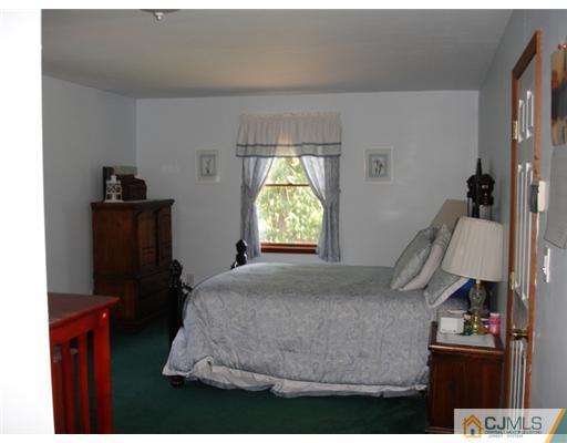800 Farmingdale Road Jackson, NJ 08527 - Photo 13 of 22 a bedroom with a bed and wooden floor