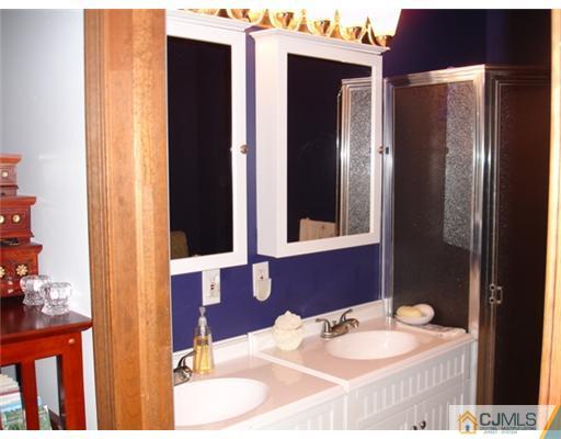 800 Farmingdale Road Jackson, NJ 08527 - Photo 15 of 22 a bathroom with a sink and a mirror