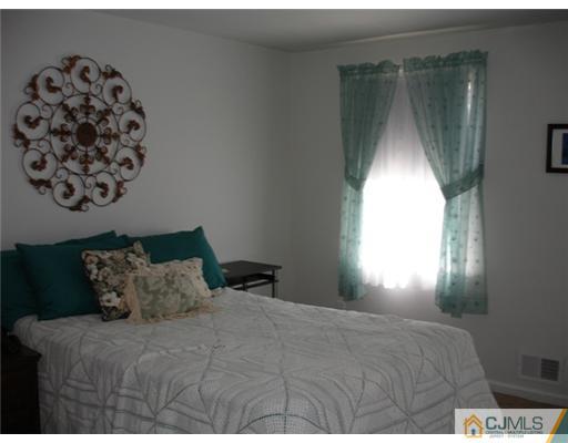 800 Farmingdale Road Jackson, NJ 08527 - Photo 16 of 22 a bedroom with a bed and a window
