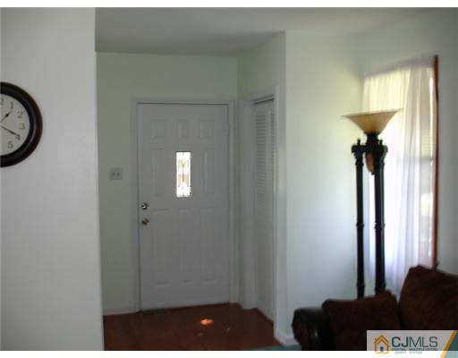 800 Farmingdale Road Jackson, NJ 08527 - Photo 19 of 22 a view of a hallway with a dining table
