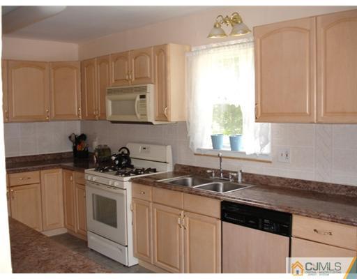 800 Farmingdale Road Jackson, NJ 08527 - Photo 5 of 22 a kitchen with stainless steel appliances granite countertop a sink stove and cabinets