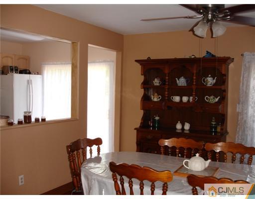 800 Farmingdale Road Jackson, NJ 08527 - Photo 6 of 22 a view of a room that has a table and chairs in it