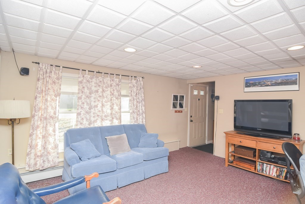 43 Russell Street Methuen, MA 01844 - Photo 32 of 37 a living room with furniture a flat screen tv and a window