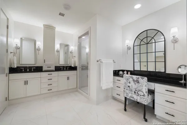 a spacious bathroom with a double vanity sink a mirror and a bathtub