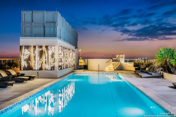 a view of a swimming pool with an outdoor seating