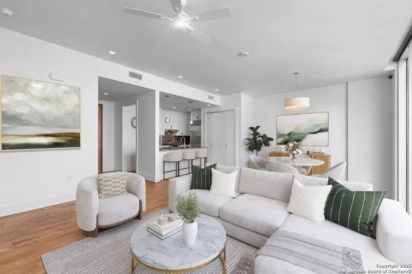 a living room with furniture and a view of kitchen