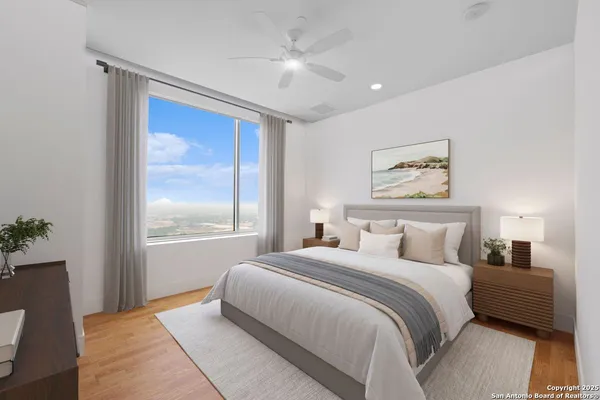 a bedroom with a large bed and a chandelier