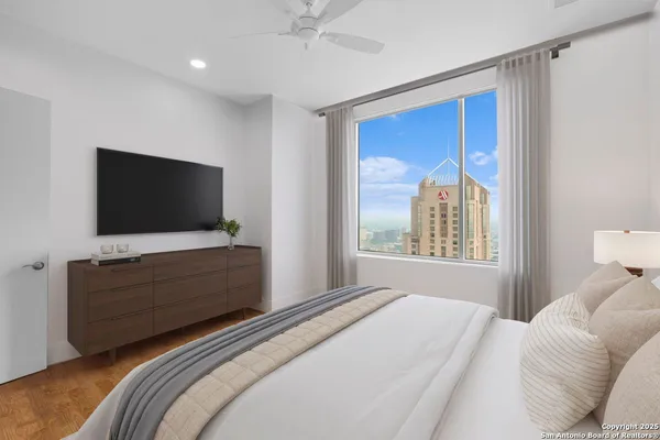 a bedroom with a bed and a flat screen tv