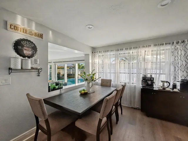 a view of a dining room with furniture and window