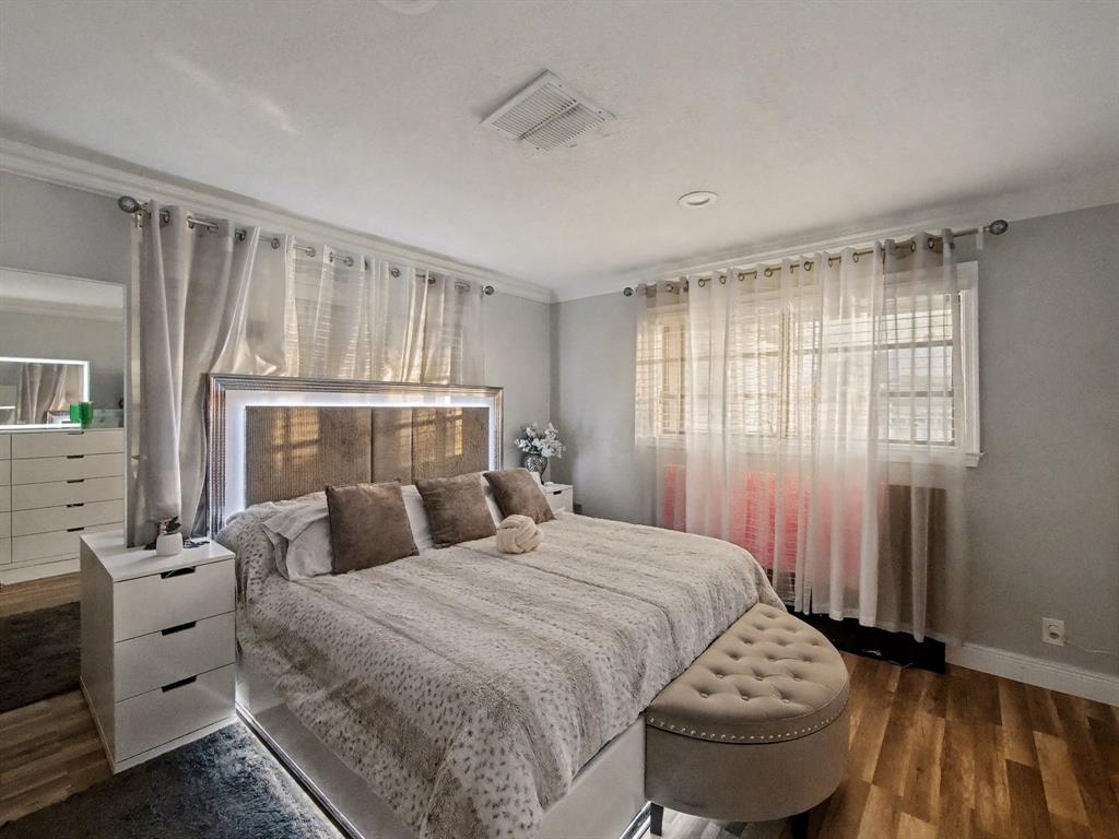 1255 Northwest 63rd Way Margate, FL 33063 - Photo 18 of 33 a bedroom with a bed and wooden floor