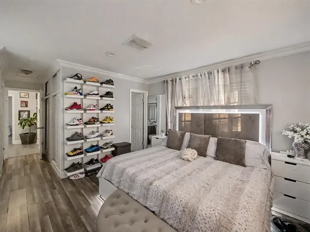 a bedroom with a large bed and a window