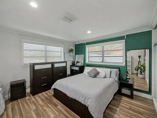 a bedroom with a bed and a dresser