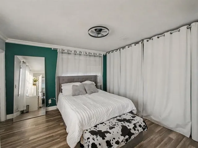 a bedroom with a bed and a window