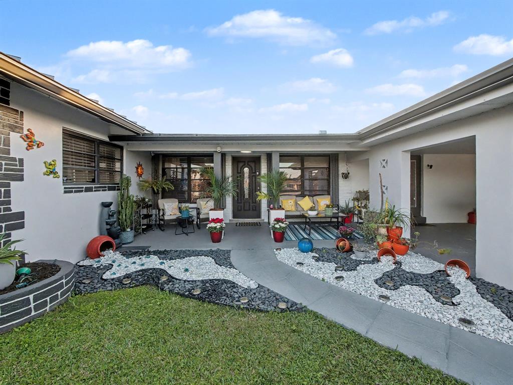 1255 Northwest 63rd Way Margate, FL 33063 - Photo 27 of 33 a view of a backyard with a patio and outdoor seating