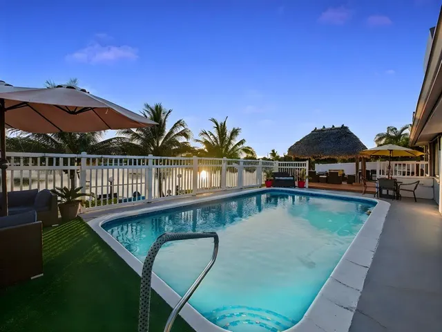 a balcony with table and chairs