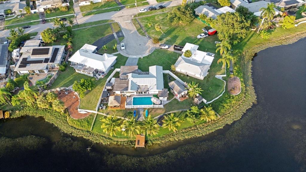 1255 Northwest 63rd Way Margate, FL 33063 - Photo 4 of 33 an aerial view of a house with a garden and lake view