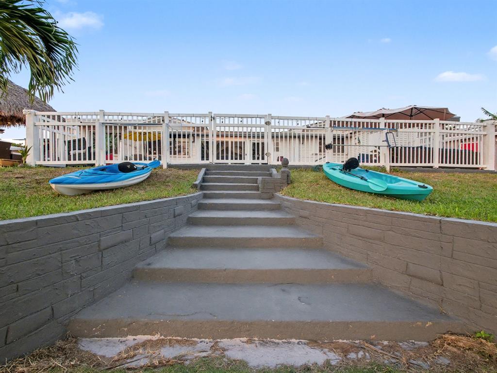 1255 Northwest 63rd Way Margate, FL 33063 - Photo 7 of 33 a view of a house with a yard and potted plants