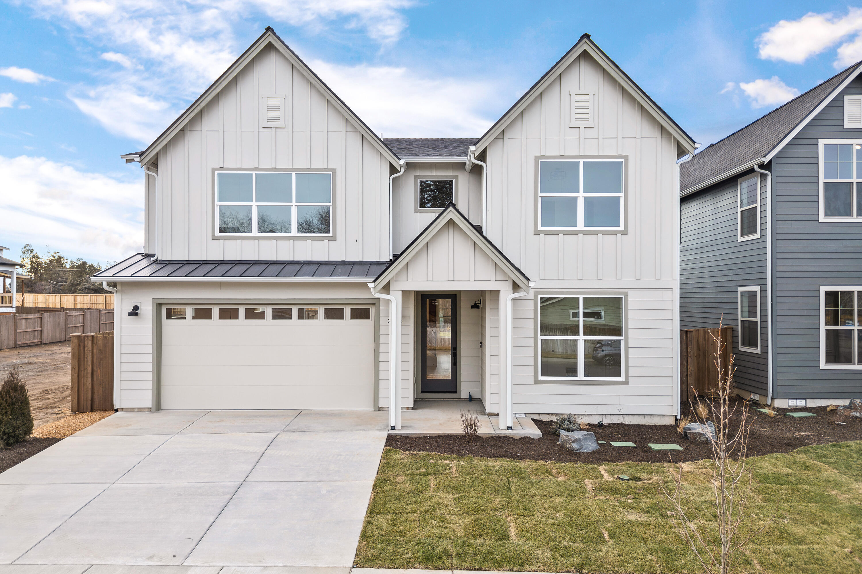 4383 Southwest Rhyolite Place, Unit 22 Redmond, OR 97756 - Photo 1 of 44 a front view of a house with a yard