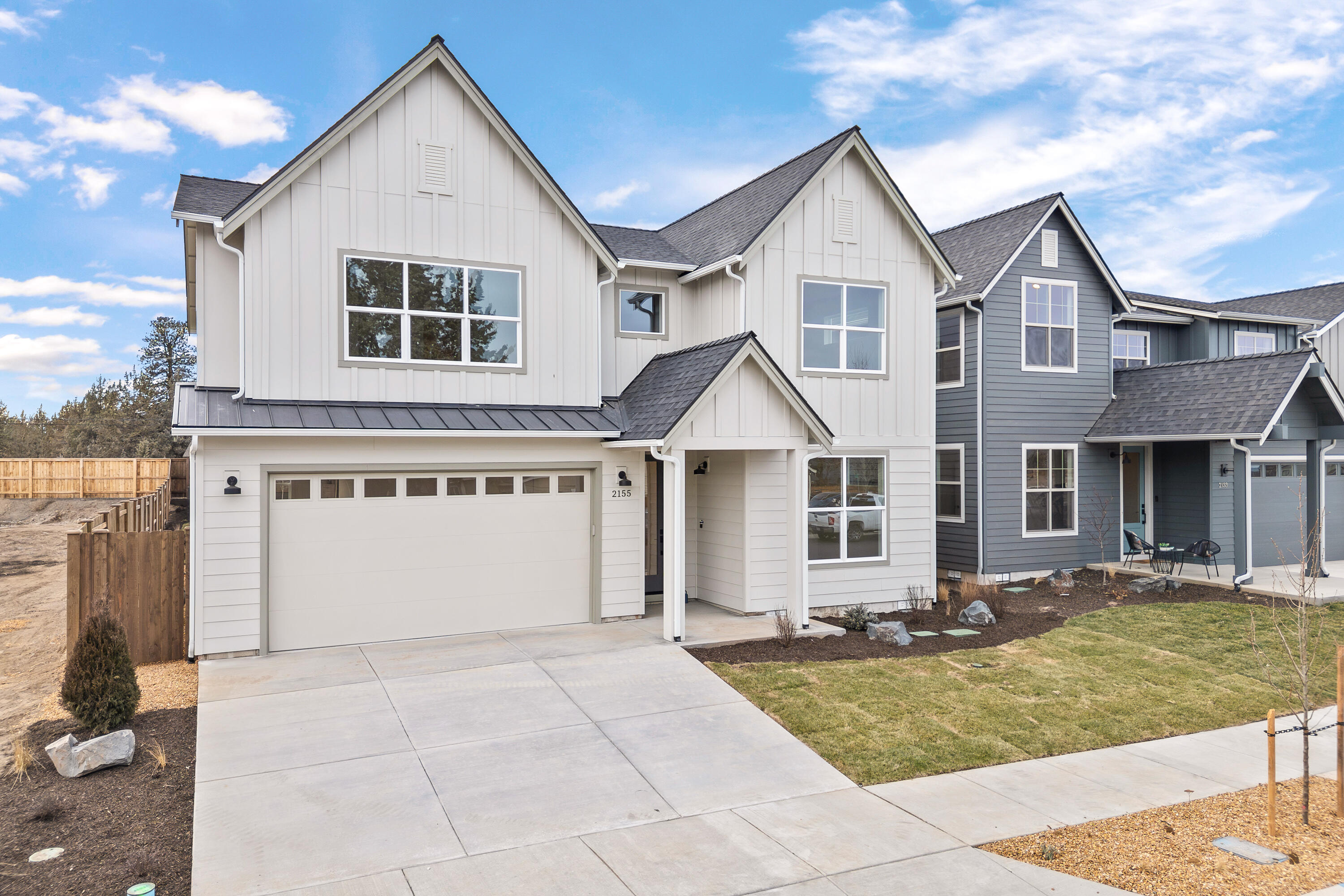 4383 Southwest Rhyolite Place, Unit 22 Redmond, OR 97756 - Photo 2 of 44 a front view of a house with a yard