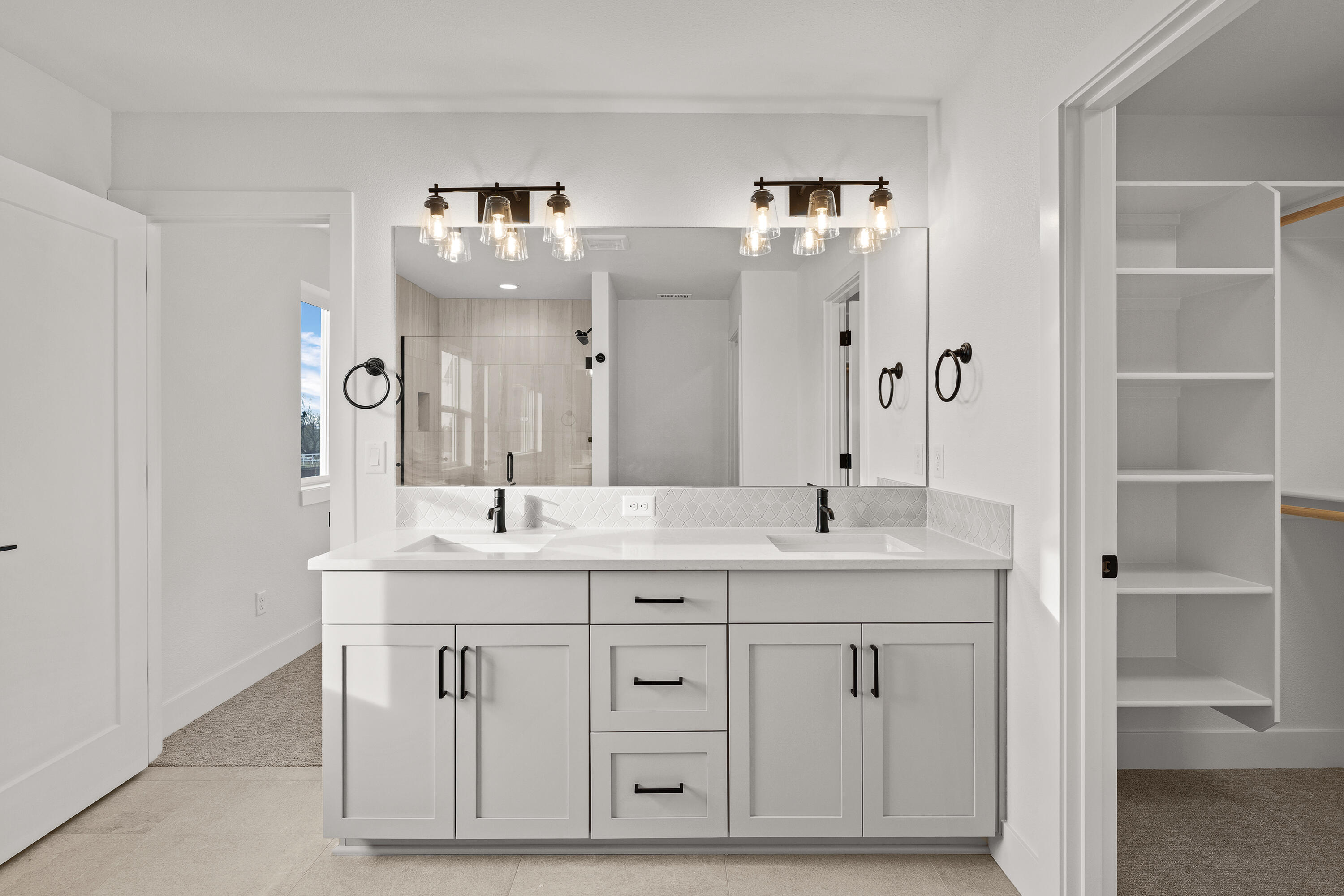 4383 Southwest Rhyolite Place, Unit 22 Redmond, OR 97756 - Photo 26 of 44 a bathroom with a double vanity sink and mirror