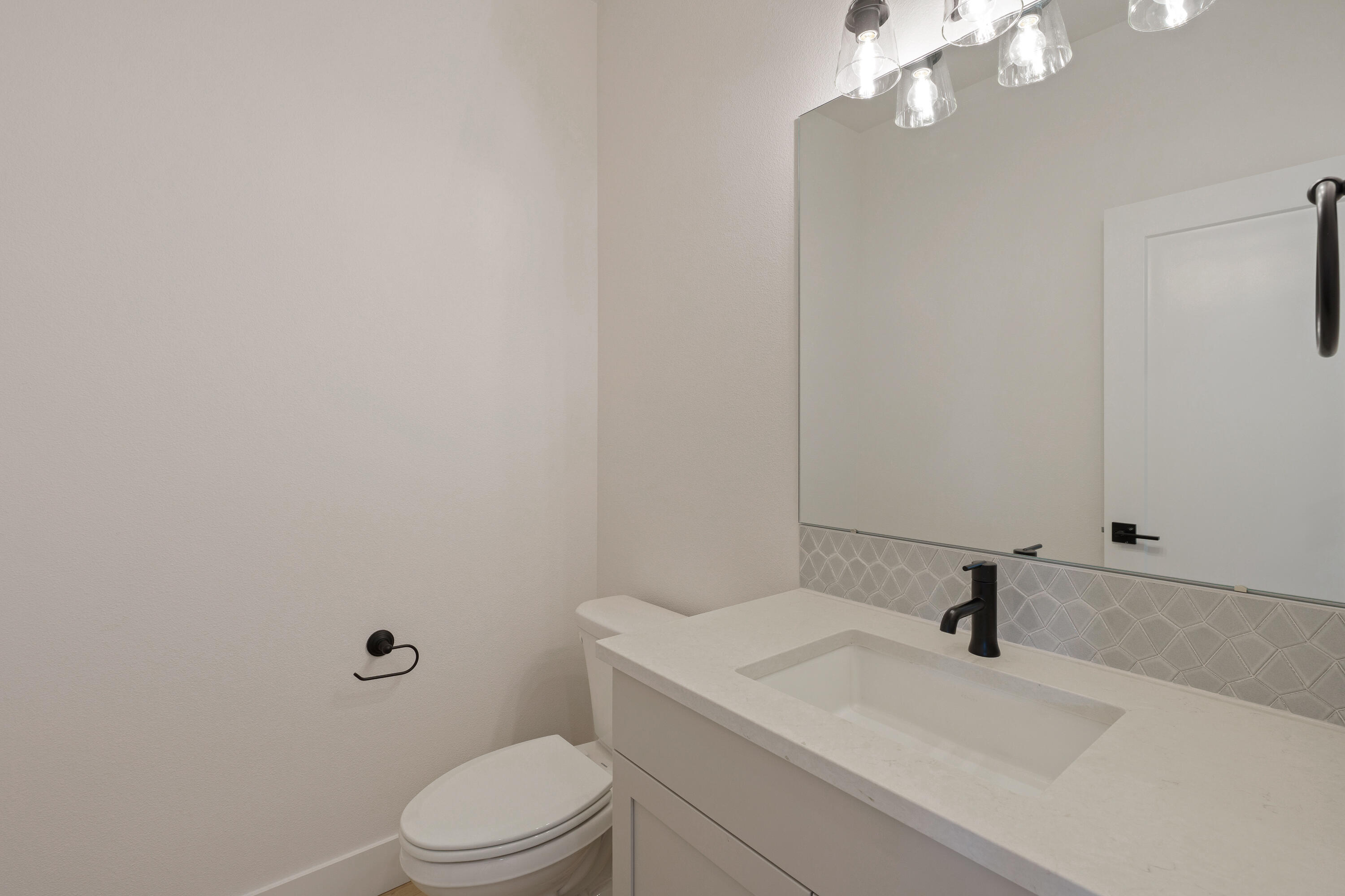 4383 Southwest Rhyolite Place, Unit 22 Redmond, OR 97756 - Photo 8 of 44 a bathroom with a sink a toilet and vanity