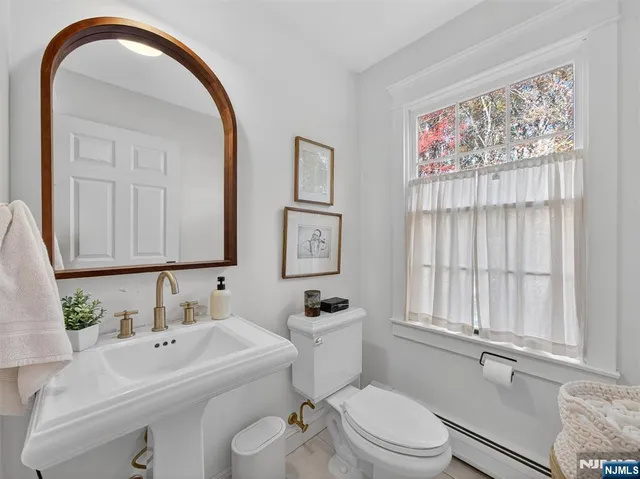 a bathroom with a sink a mirror and a toilet