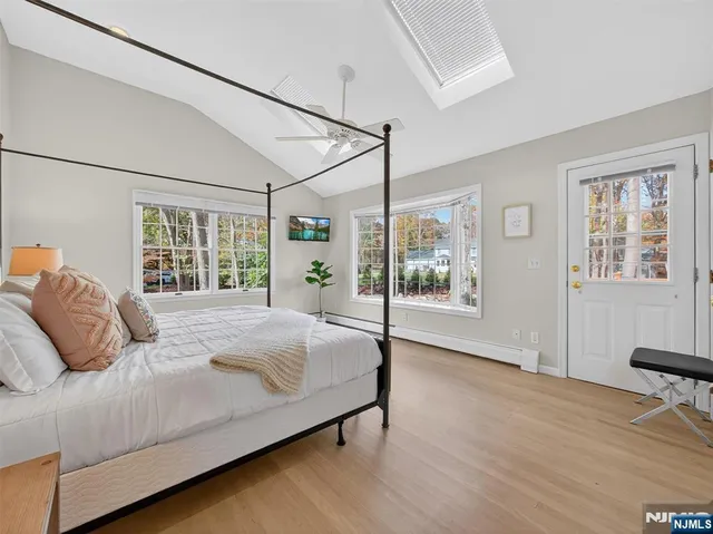 a bedroom with a large bed and a window