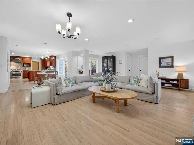 a living room with fireplace furniture and a wooden floor