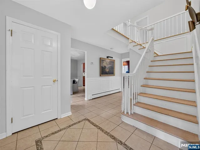 a view of entryway with stairs and a front door