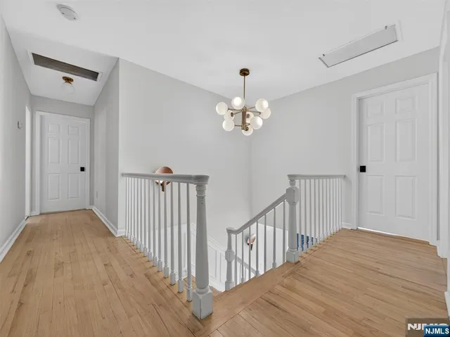 a view of a hallway view with wooden floor and staircase
